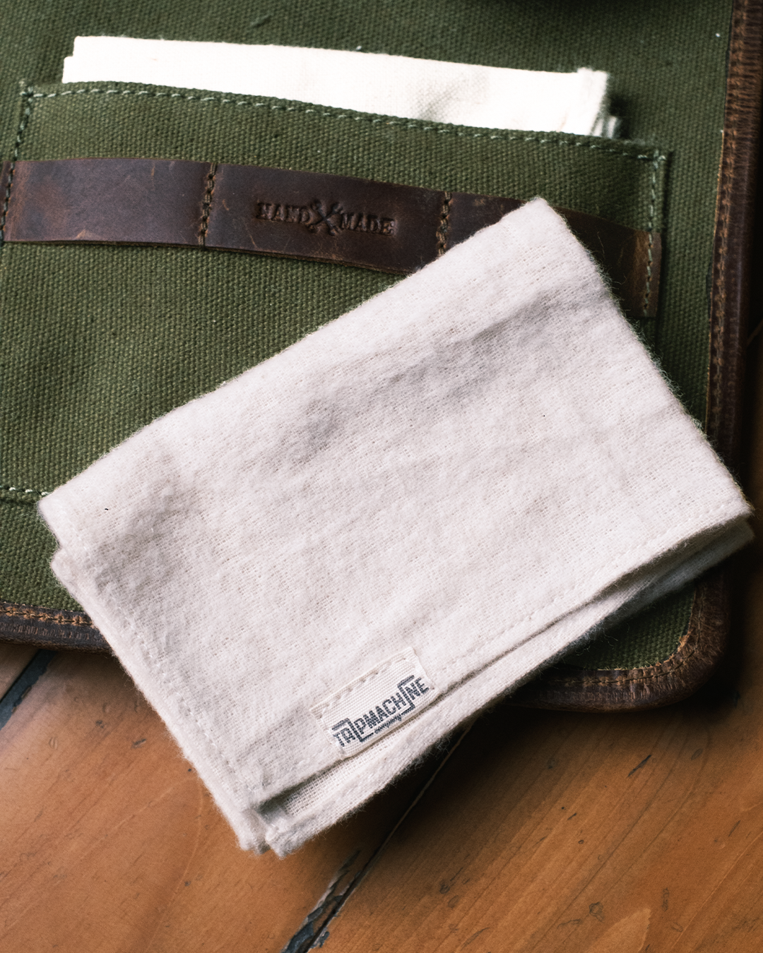 Folded cloth with 'Trip Machine' branding on a green fabric background